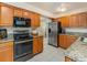 Kitchen features stainless steel appliances, granite countertops, and ample cabinet space for storage at 15789 Sandtrap Way, Morrison, CO 80465