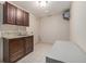 Spacious laundry room with granite countertops, sink and dark cabinetry at 15789 Sandtrap Way, Morrison, CO 80465