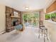 Living room with a stone fireplace, sliding doors to the balcony, and lots of light at 15789 Sandtrap Way, Morrison, CO 80465