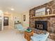Living room features stone fireplace, comfortable seating, and views to other areas of the home at 15789 Sandtrap Way, Morrison, CO 80465