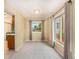 Neutral living room with lots of light, carpeting, and a pass-through to the kitchen at 15789 Sandtrap Way, Morrison, CO 80465