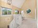 Upper level hallway and sitting area with bright, neutral walls and carpet, and an abundance of natural light at 15789 Sandtrap Way, Morrison, CO 80465