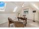 Cozy home office with skylights and a standard window featuring a ceiling fan and desk setup at 15789 Sandtrap Way, Morrison, CO 80465