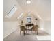 Bright office space with skylights and a window features a desk and two armchairs at 15789 Sandtrap Way, Morrison, CO 80465