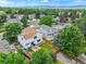Aerial view showcasing a fenced backyard with a patio, surrounded by lush greenery and neighborhood trees at 9717 Castle Ridge Cir, Highlands Ranch, CO 80129
