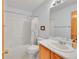 Well lit bathroom featuring a toilet, sink, vanity, and bathtub with shower at 9717 Castle Ridge Cir, Highlands Ranch, CO 80129