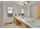 Bright bathroom featuring double sinks, a large mirror, and bathtub with shower at 9717 Castle Ridge Cir, Highlands Ranch, CO 80129