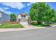 Charming two-story home with a lush green lawn and a two car garage at 9717 Castle Ridge Cir, Highlands Ranch, CO 80129