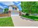 Beautiful two-story home with a well-manicured lawn and an attached two car garage at 9717 Castle Ridge Cir, Highlands Ranch, CO 80129