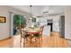 Charming eat-in kitchen featuring wood floors, stainless steel appliances, and sliding door to yard at 9717 Castle Ridge Cir, Highlands Ranch, CO 80129