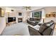 Comfortable living room featuring a fireplace, ceiling fan, and plush leather seating at 9717 Castle Ridge Cir, Highlands Ranch, CO 80129