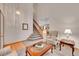 Bright living room with a vaulted ceiling, carpeted floors and wood entry at 9717 Castle Ridge Cir, Highlands Ranch, CO 80129