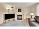 Comfortable living room with fireplace, television, and plush leather seating at 9717 Castle Ridge Cir, Highlands Ranch, CO 80129