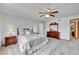 Spacious main bedroom with ceiling fan, carpet floors, and a view of the neighborhood. Large walk in closet at 9717 Castle Ridge Cir, Highlands Ranch, CO 80129