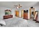 Spacious main bedroom with ceiling fan, carpet floors, and a view of the neighborhood. Large walk in closet at 9717 Castle Ridge Cir, Highlands Ranch, CO 80129