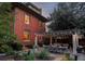 Brick two-story home with patio, pergola, outdoor seating, and mature trees at 1275 N Franklin St, Denver, CO 80218