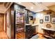 Basement bar area complete with custom cabinets, a wine cooler, and under-cabinet lighting at 1275 N Franklin St, Denver, CO 80218