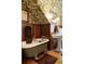 Vintage-style bathroom with wood paneled walls, a soaking tub, and decorative leafy wallpaper at 1275 N Franklin St, Denver, CO 80218