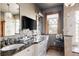 Bathroom featuring double sinks, stone countertops, a large mirror and a glass enclosed shower at 1275 N Franklin St, Denver, CO 80218