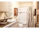Bathroom featuring a vanity with marbled top and shower with patterned curtain at 1275 N Franklin St, Denver, CO 80218
