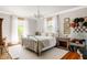 Bright bedroom featuring a chandelier, metal bed frame, hardwood floors, and sunny windows at 1275 N Franklin St, Denver, CO 80218