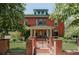 Stunning brick home featuring manicured lawn, landscaped yard, and brick fence at 1275 N Franklin St, Denver, CO 80218