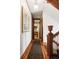Hallway featuring wood floors and trim, and an elaborate painting at 1275 N Franklin St, Denver, CO 80218