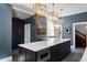 Kitchen island with granite countertops, custom cabinets, stainless steel appliances, and pendant lighting at 1275 N Franklin St, Denver, CO 80218