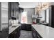 Contemporary kitchen with sleek dark cabinets, stainless steel appliances, and stylish lighting fixtures at 1275 N Franklin St, Denver, CO 80218