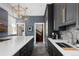 Modern kitchen featuring sleek dark cabinets, stainless steel appliances, and a spacious island at 1275 N Franklin St, Denver, CO 80218