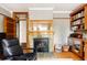 Living room featuring a cozy fireplace with tile surround, built-in shelves, and wood floors at 1275 N Franklin St, Denver, CO 80218
