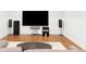 Entertainment area in a finished basement features a large flatscreen television and speakers at 1275 N Franklin St, Denver, CO 80218