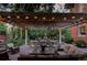 Outdoor patio featuring a pergola illuminated with string lights, comfortable seating, and landscaped surroundings at 1275 N Franklin St, Denver, CO 80218