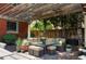 Outdoor patio with wicker furniture, potted plants, a wooden pergola, and access to the lush backyard at 1275 N Franklin St, Denver, CO 80218