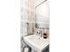 Stylish powder room with decorative wallpaper, a modern sink, and sleek fixtures at 1275 N Franklin St, Denver, CO 80218