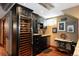Wet bar with dark cabinets includes a large wine refrigerator and marble counter at 1275 N Franklin St, Denver, CO 80218
