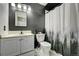 Bathroom boasts a white vanity and a shower curtain with a forest scene at 2551 S Carson Way, Aurora, CO 80014