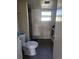 Bathroom featuring dark tile floors, a toilet, a standing shower, and a washing machine at 2551 S Carson Way, Aurora, CO 80014