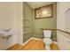 Compact bathroom features a toilet and sink at 2551 S Carson Way, Aurora, CO 80014