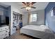 Bedroom featuring a ceiling fan, wood floor, and an open closet with shelves and drawers at 2551 S Carson Way, Aurora, CO 80014