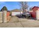 Detached garage features a white door, concrete driveway, and is partially obscured by an old truck at 2551 S Carson Way, Aurora, CO 80014