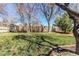 Landscaped backyard featuring a storage shed, mature trees, and privacy fence for outdoor enjoyment at 11651 E Yale Way, Aurora, CO 80014