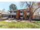 Expansive backyard features a seating area, green lawn, mature trees, and well-maintained landscaping at 11651 E Yale Way, Aurora, CO 80014