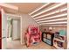 Play area in basement with stairs, playhouse, and ample storage space at 11651 E Yale Way, Aurora, CO 80014