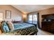 Comfortable bedroom features a queen bed, lots of natural light and closet at 11651 E Yale Way, Aurora, CO 80014