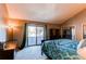 Spacious main bedroom featuring a private balcony, vaulted ceiling, and mirrored closet at 11651 E Yale Way, Aurora, CO 80014