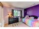 This bedroom features whimsical decor, a dresser, and natural light at 11651 E Yale Way, Aurora, CO 80014