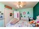 A bedroom offers whimsical decor and a ceiling fan for comfort at 11651 E Yale Way, Aurora, CO 80014