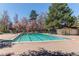 Community pool surrounded by lush landscaping, shade trees, and seating areas for residents' enjoyment at 11651 E Yale Way, Aurora, CO 80014