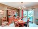 Cozy dining room with wood table set, a china cabinet, and a sliding glass door leading to the patio at 11651 E Yale Way, Aurora, CO 80014